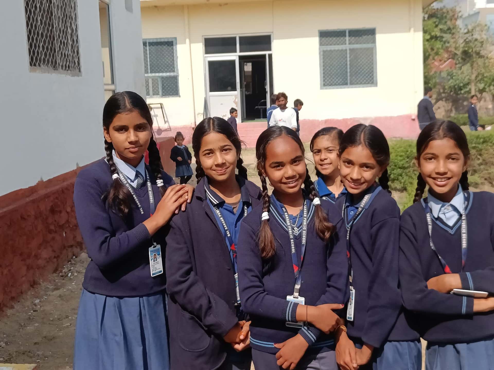 BSPS girls smiling in winter uniform outside the school building